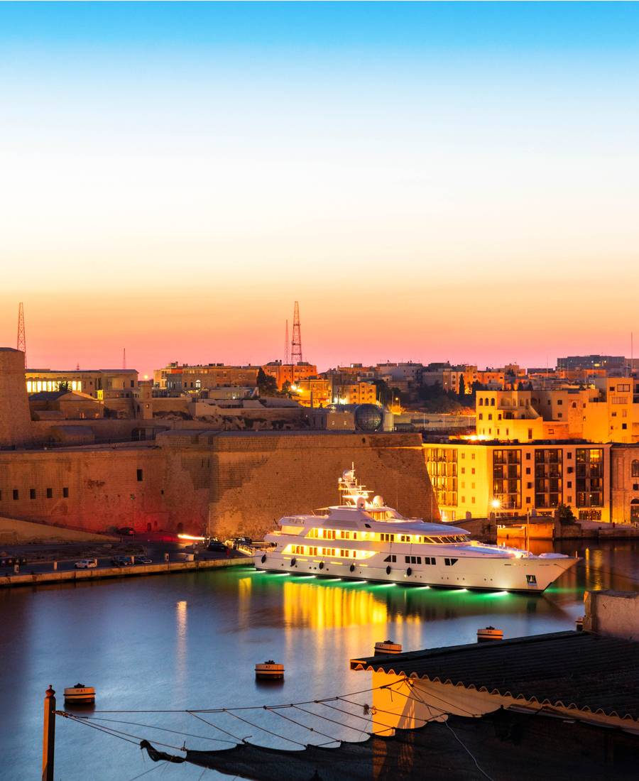 Lit Up Superyacht In Malta Harbour At Dusk