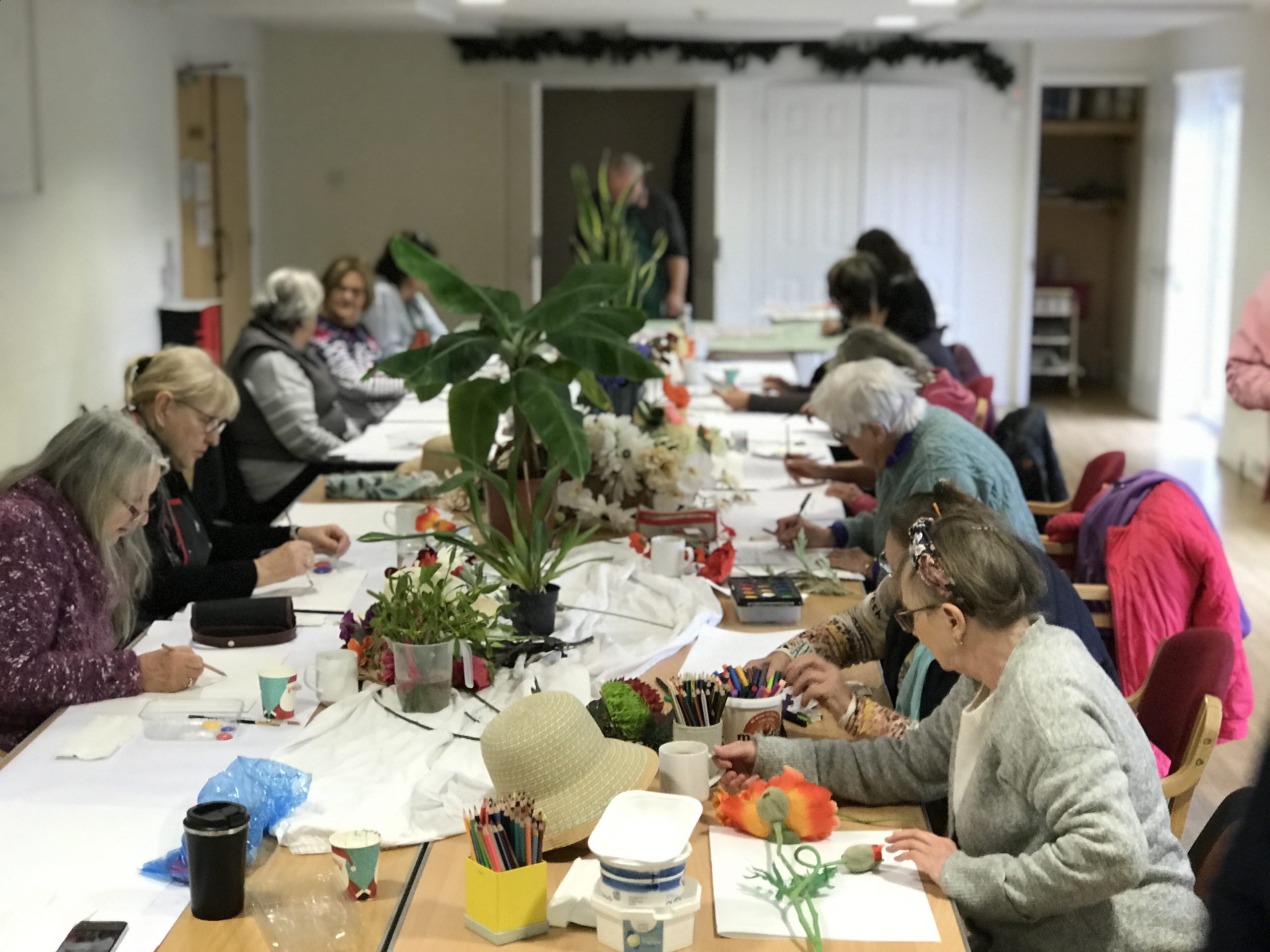 A group of elderly woman doing arts and crafts