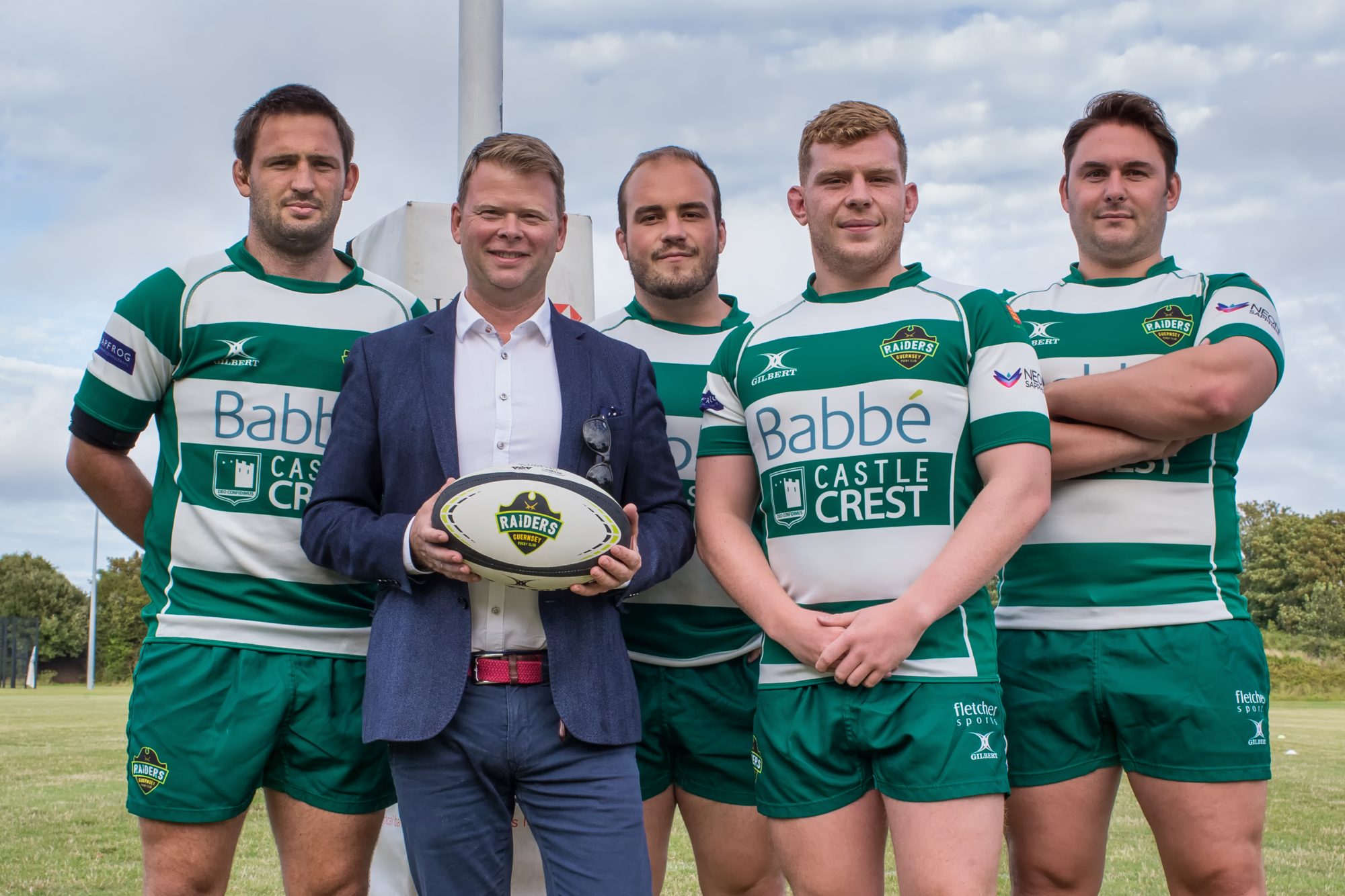 Matt Litten posing with 4 of the Guernsey Raiders rugby team on the Rugby field