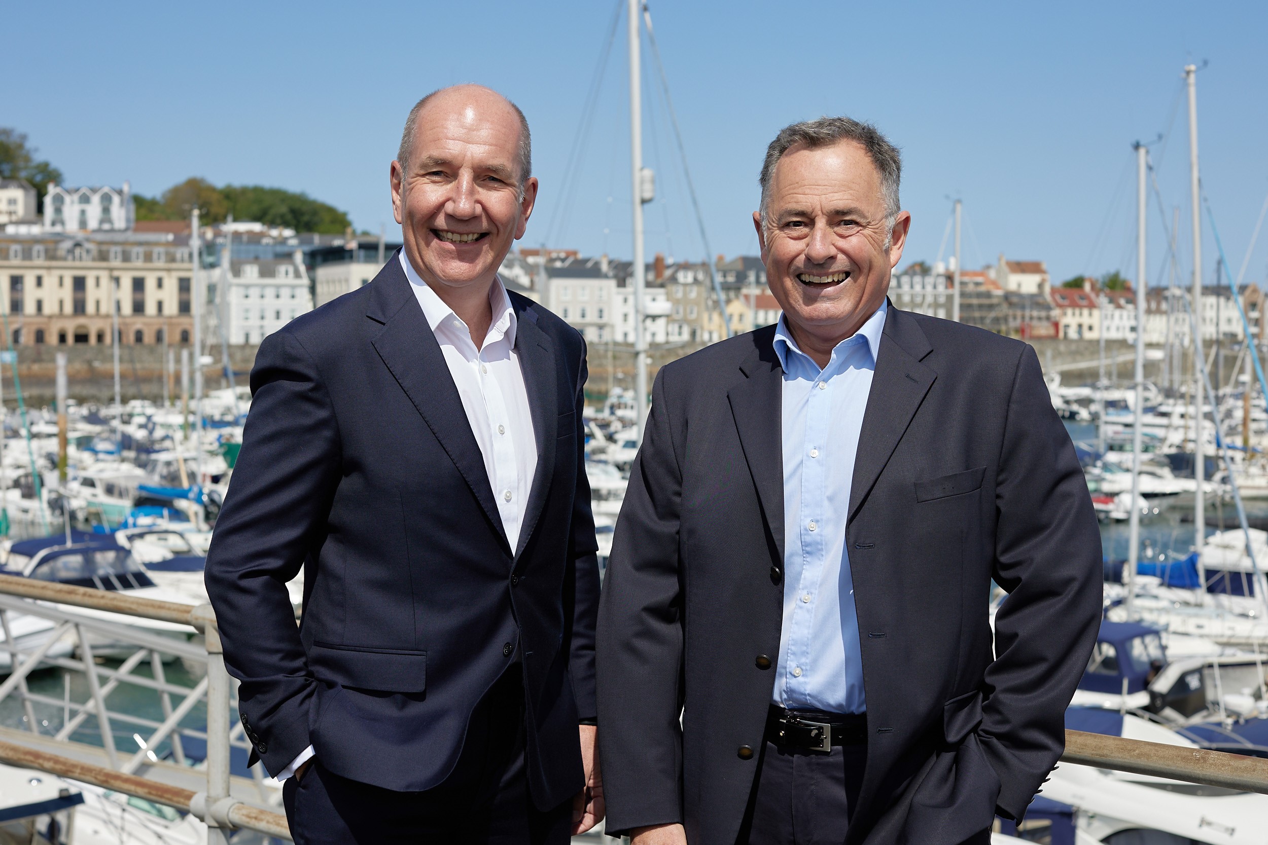 Rob Fearis and Tim Joyce in front of boats in St Peter Port harbour