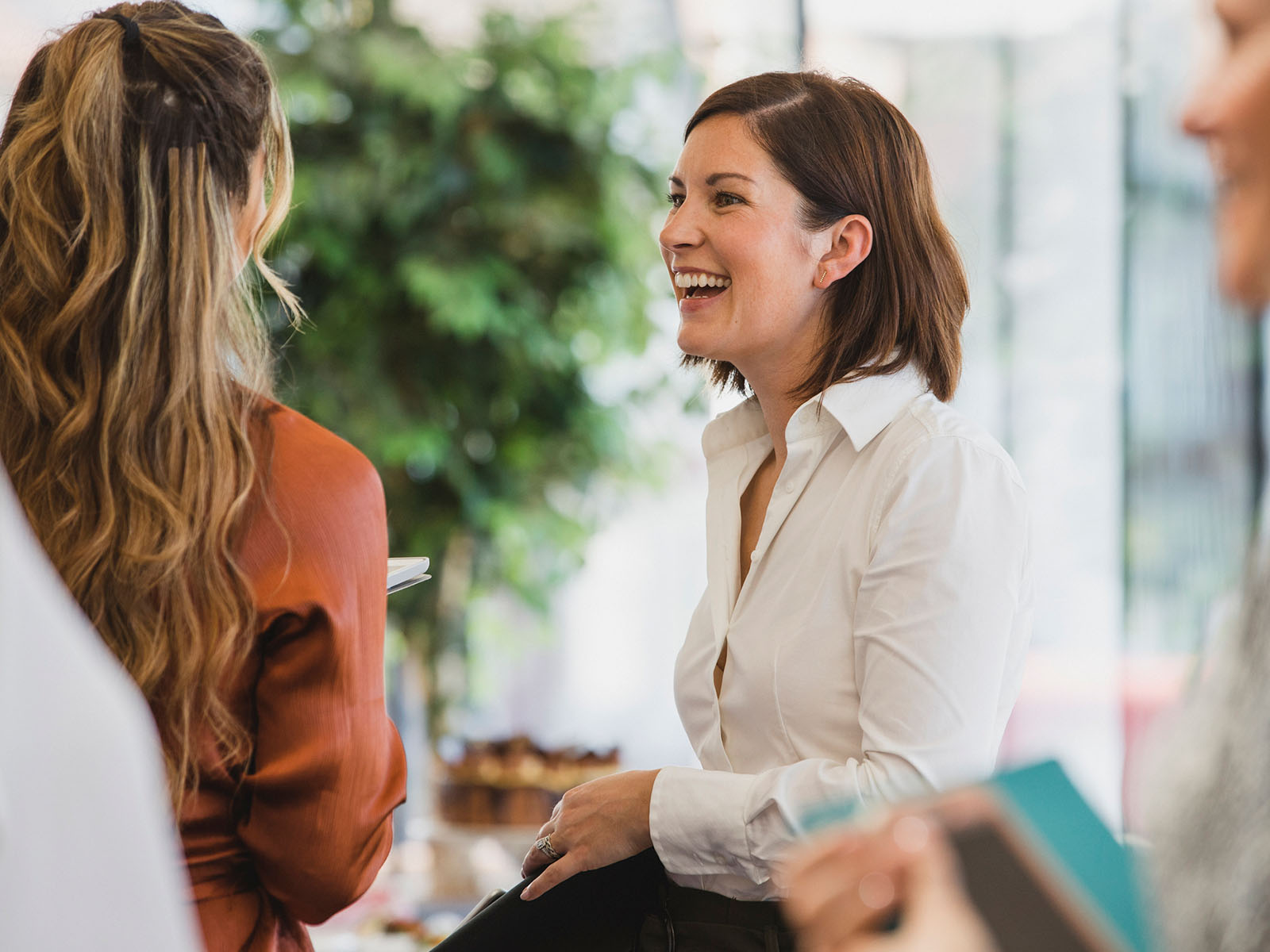 Two women having an enjoyable conversation in a professional setting